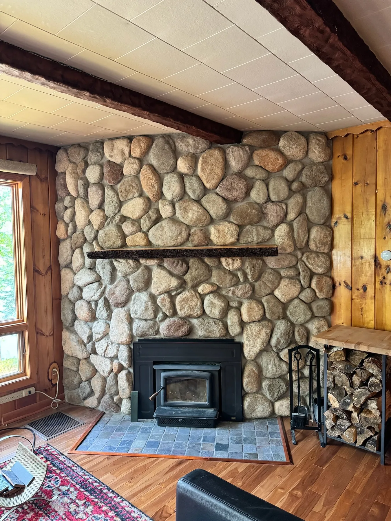 Cloudscape Cabin: Upgraded wood stove and refaced surround, 2024, before