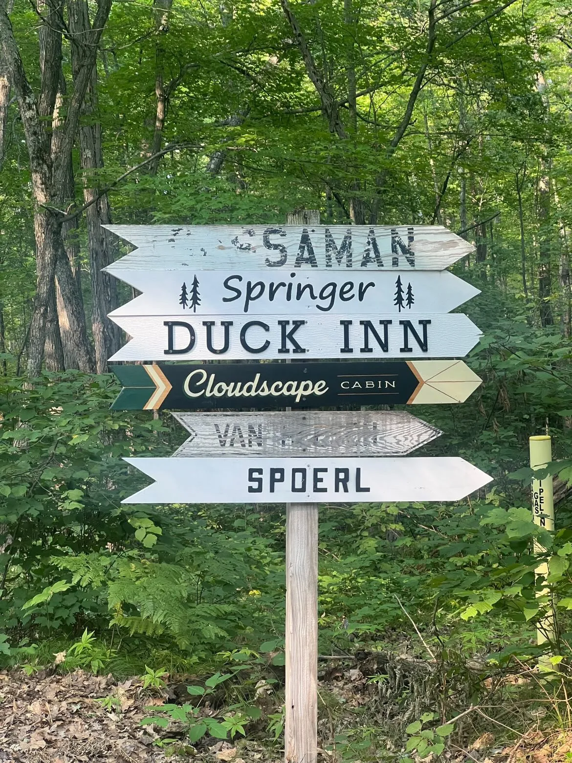 Hand painted directional sign with the Cloudscape Cabin arrow