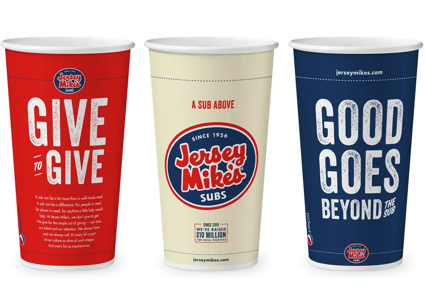 Three Jersey Mike's cups: Give to Give in red, the logo in cream, Good Goes Beyond the Sub in navy